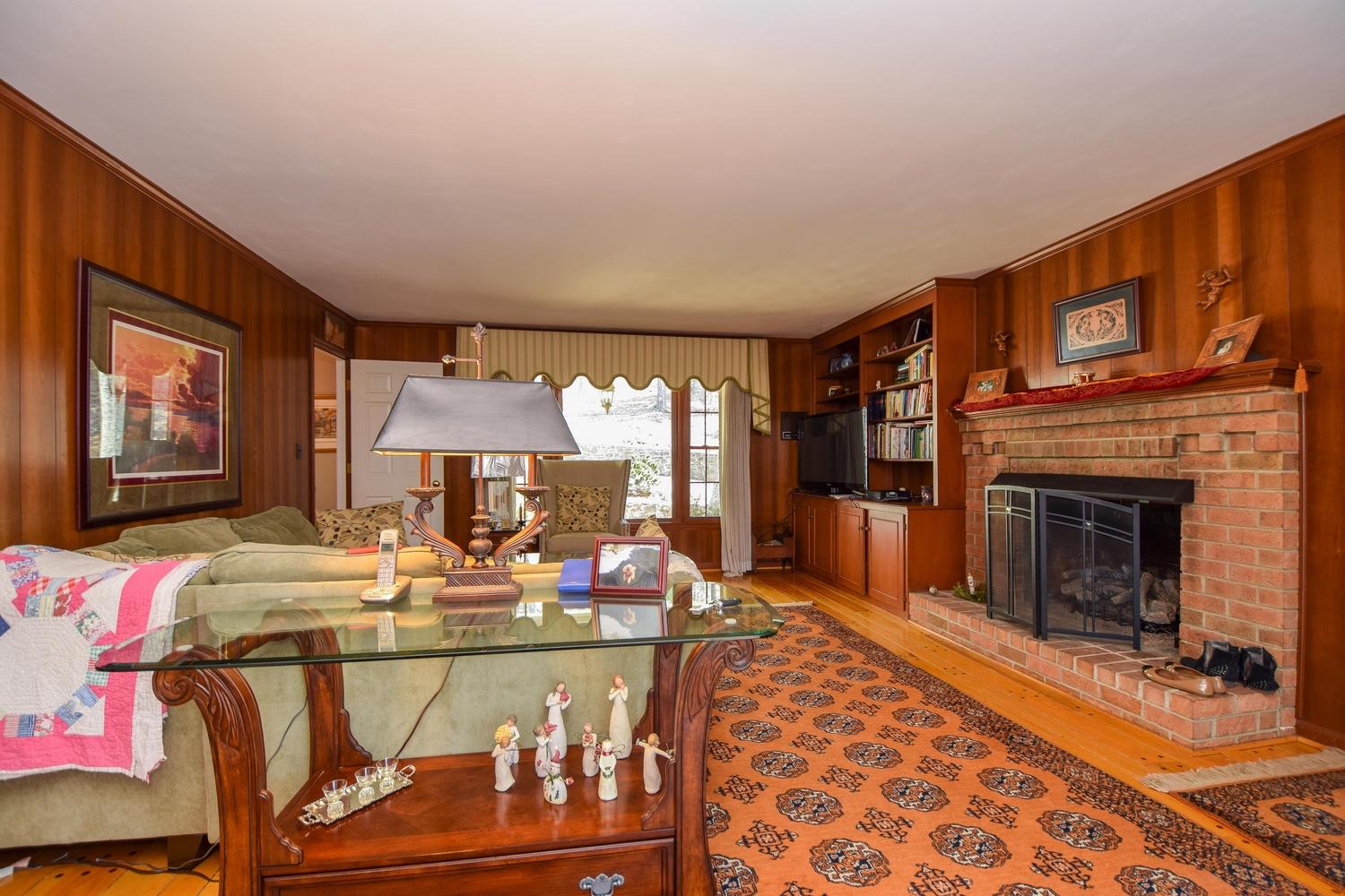 5222 Falcon Ridge Road Roanoke, VA 24018 - Photo 11 of 40 a living room with furniture a fireplace and a flat screen tv
