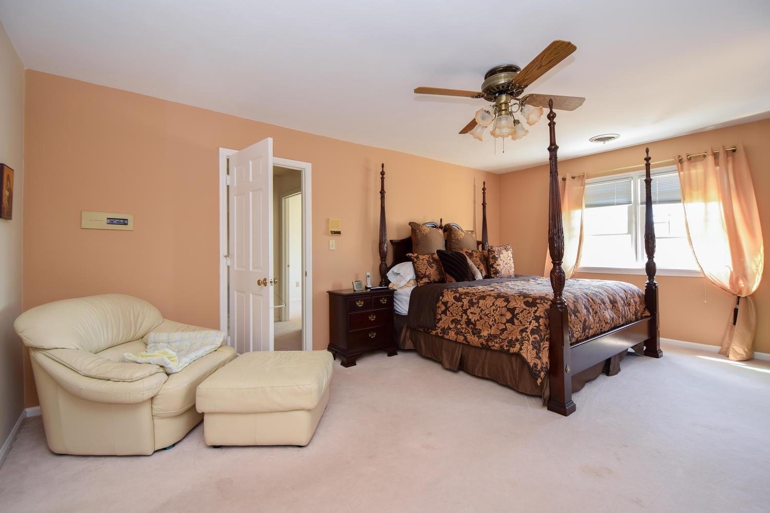5222 Falcon Ridge Road Roanoke, VA 24018 - Photo 15 of 40 a bedroom with a bed and a chandelier