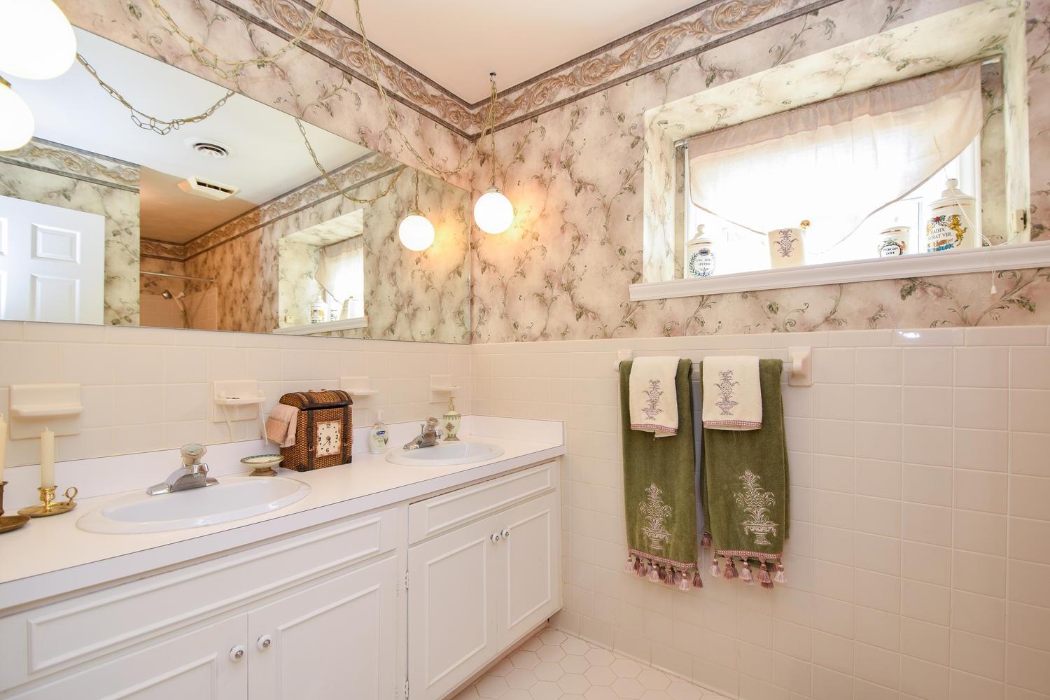 5222 Falcon Ridge Road Roanoke, VA 24018 - Photo 22 of 40 a bathroom with a sink and a mirror