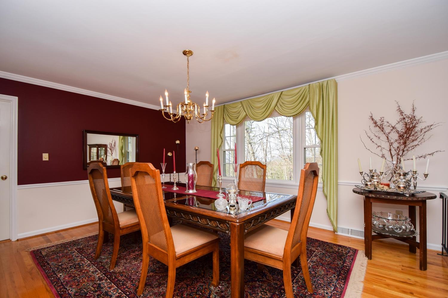 5222 Falcon Ridge Road Roanoke, VA 24018 - Photo 5 of 40 a dining room with furniture a chandelier and wooden floor