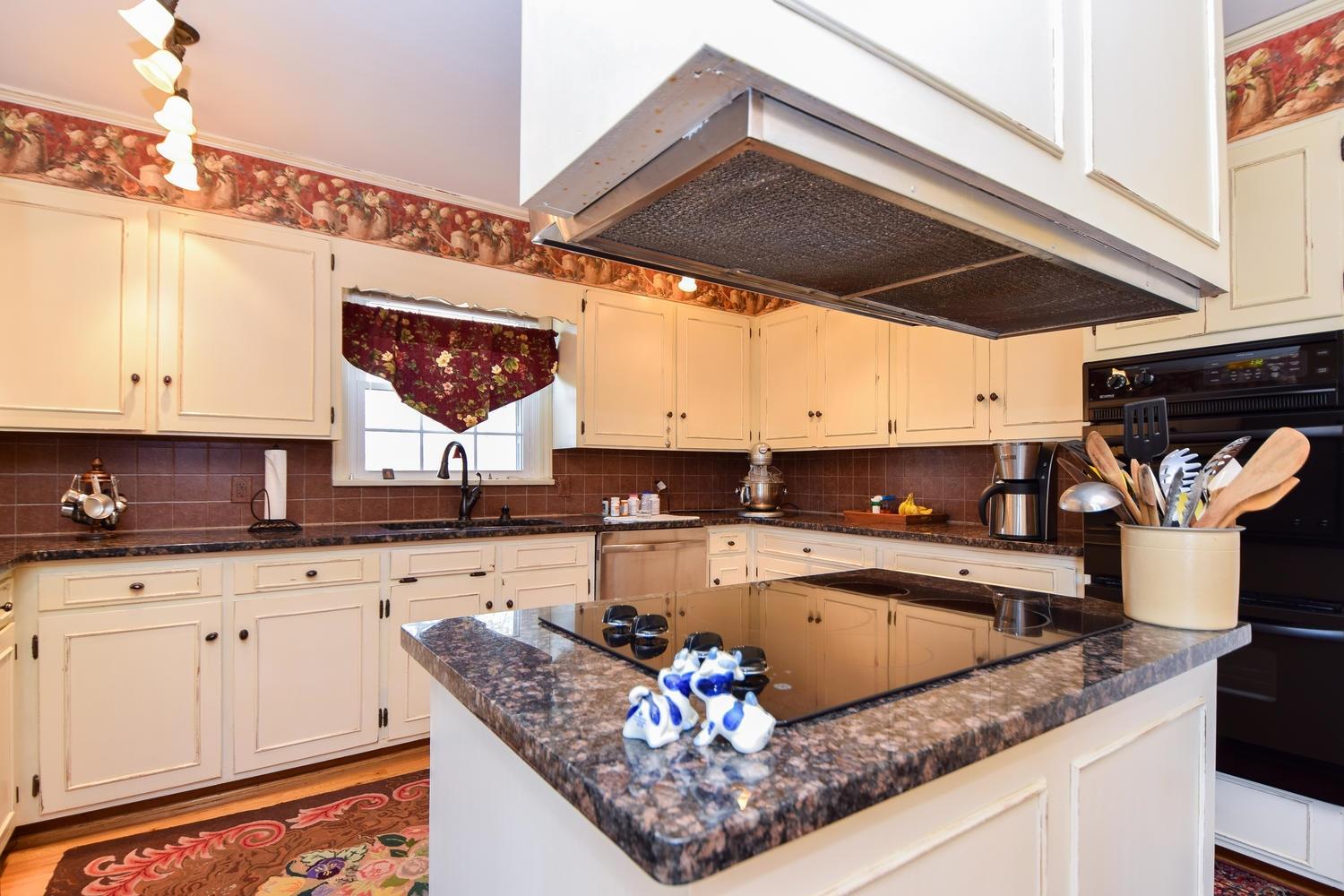 5222 Falcon Ridge Road Roanoke, VA 24018 - Photo 9 of 40 a kitchen with a stove a sink and cabinets