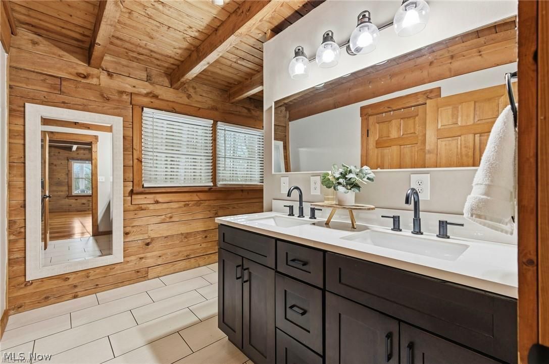 5352 Lance Road Medina, OH 44256 - Photo 19 of 43 Full bathroom featuring double vanity, wood walls, and a wooden ceiling with exposed beams