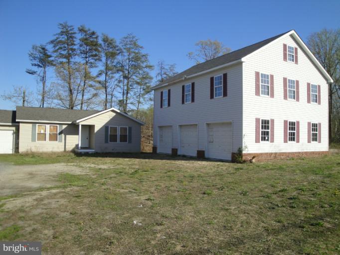3975 Solomons Island Road North Huntingtown, MD 20639 - Photo 1 of 30 a large house with a big yard and large trees
