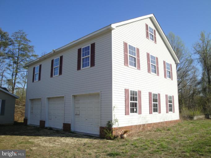 3975 Solomons Island Road North Huntingtown, MD 20639 - Photo 3 of 30 a front view of a house with a yard