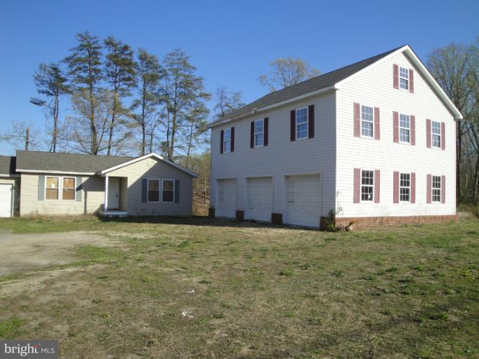 3975 Solomons Island Road North Huntingtown, MD 20639 - Photo 5 of 30 a large house with a big yard and large trees