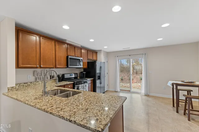 a kitchen with a stove a sink and a microwave