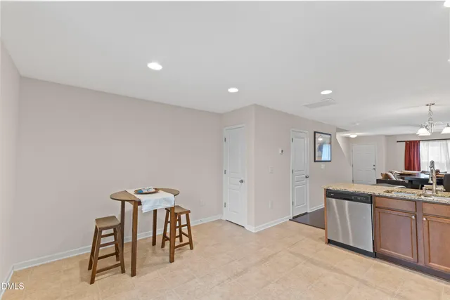 a kitchen with a table and chairs