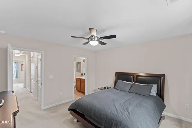 a bedroom with a bed and a ceiling fan