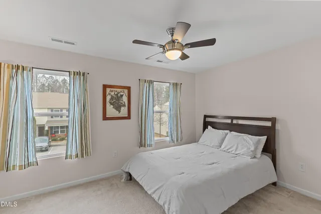 a bedroom with a large bed and a window