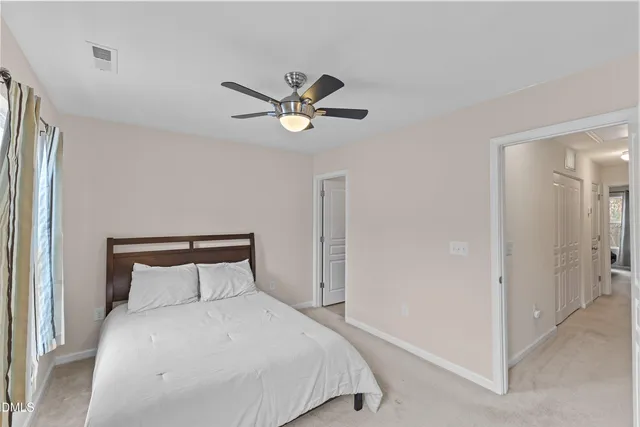 a bedroom with a bed and a ceiling fan