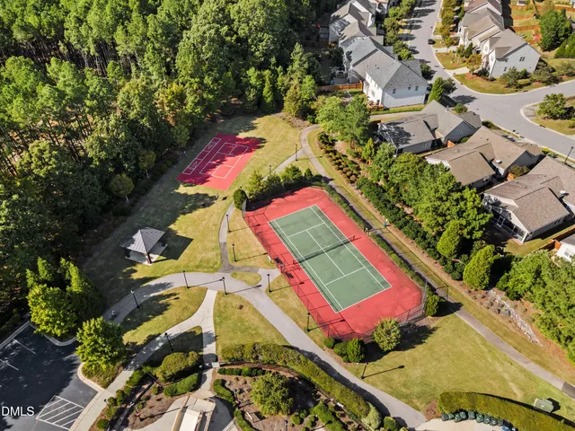 an aerial view of a house with swimming pool and outdoor seating