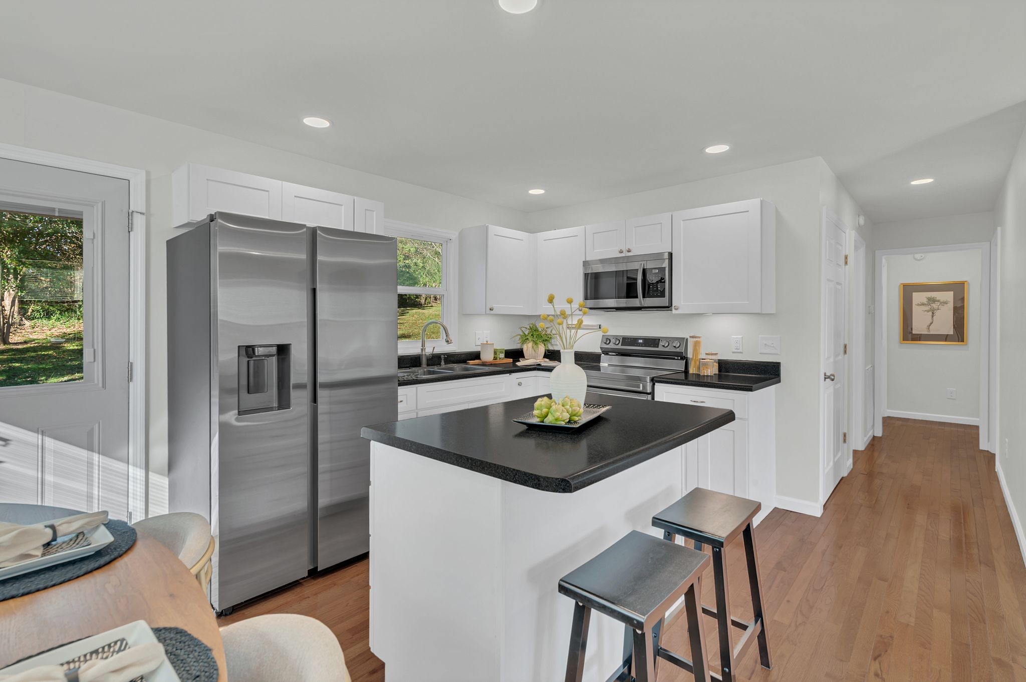 44 Flint Drive Decherd, TN 37324 - Photo 11 of 31 a kitchen with stainless steel appliances granite countertop a refrigerator a stove a sink a dining table and chairs