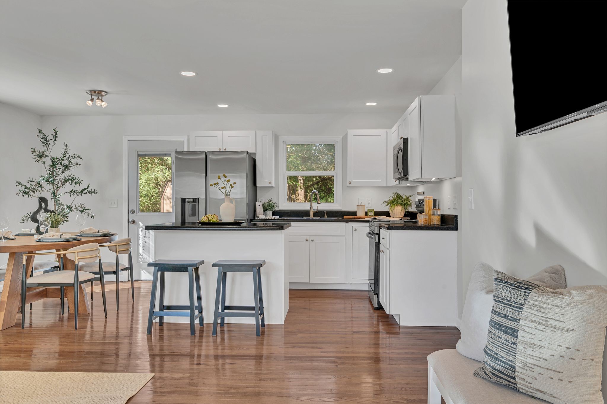 44 Flint Drive Decherd, TN 37324 - Photo 5 of 31 a kitchen with stainless steel appliances granite countertop a refrigerator a stove and white cabinets with wooden floor