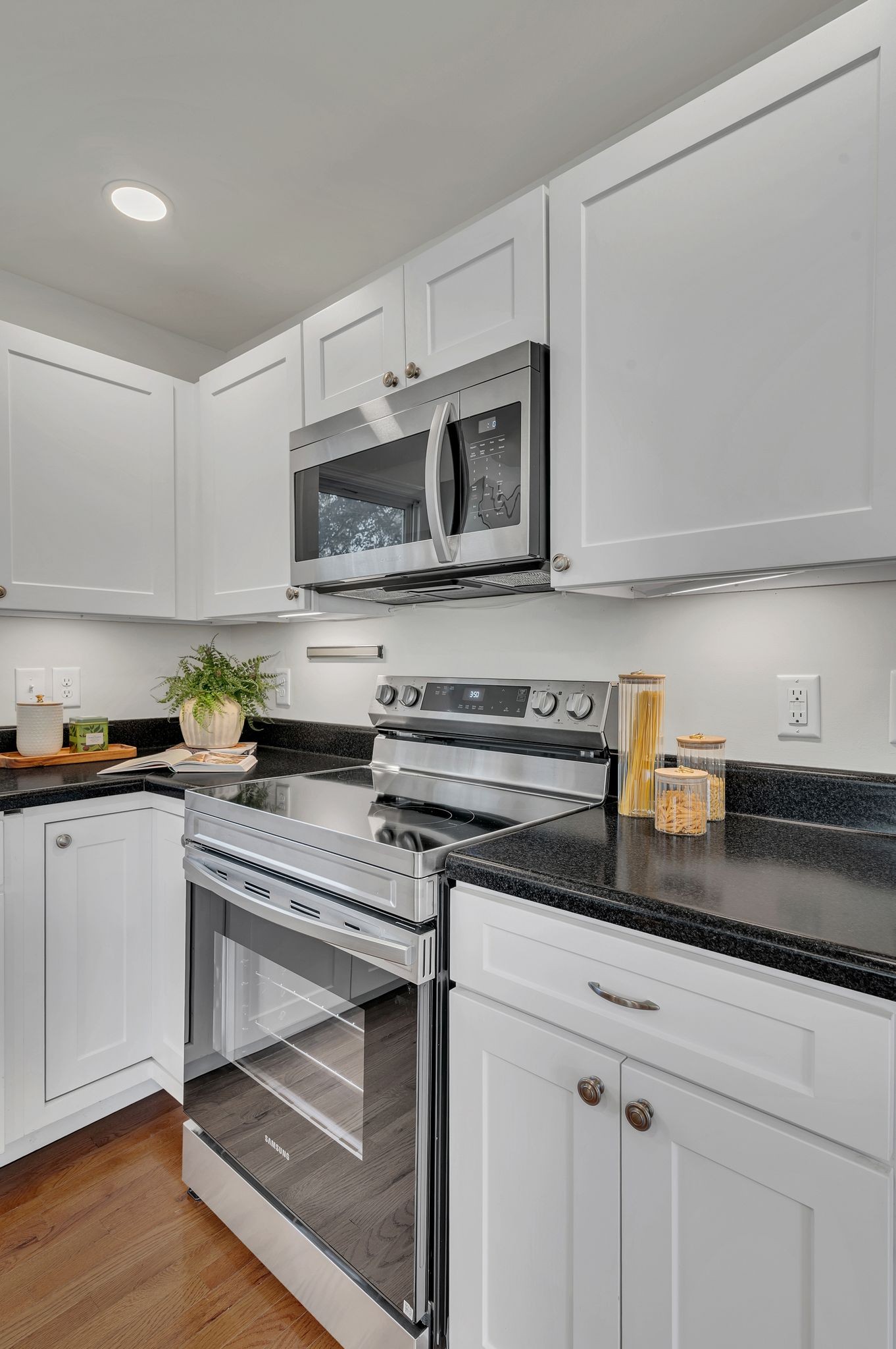 44 Flint Drive Decherd, TN 37324 - Photo 10 of 31 a kitchen with stainless steel appliances a stove microwave and cabinets