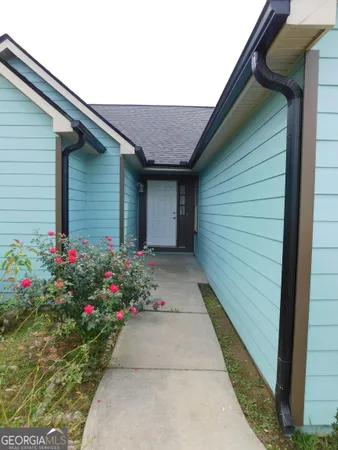 a flower garden is sitting in front of a door