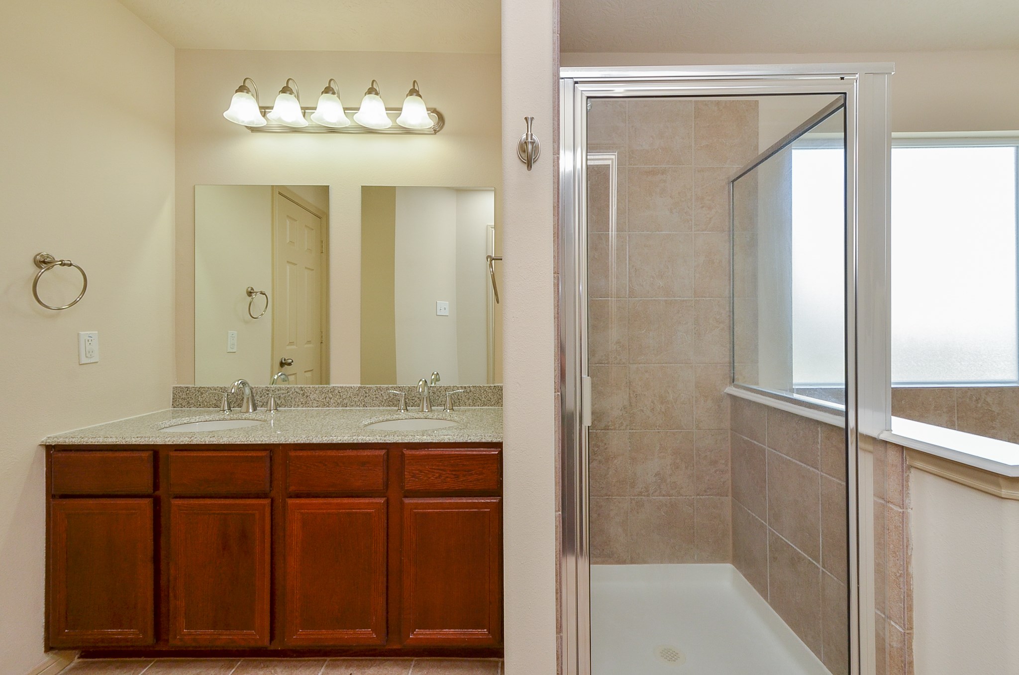 25135 Ginger Ranch Drive Katy, TX 77494 - Photo 21 of 32 Primary bath: This spacious primary bath features a separate glass-enclosed shower and dual-sink vanity for everyday convenience.