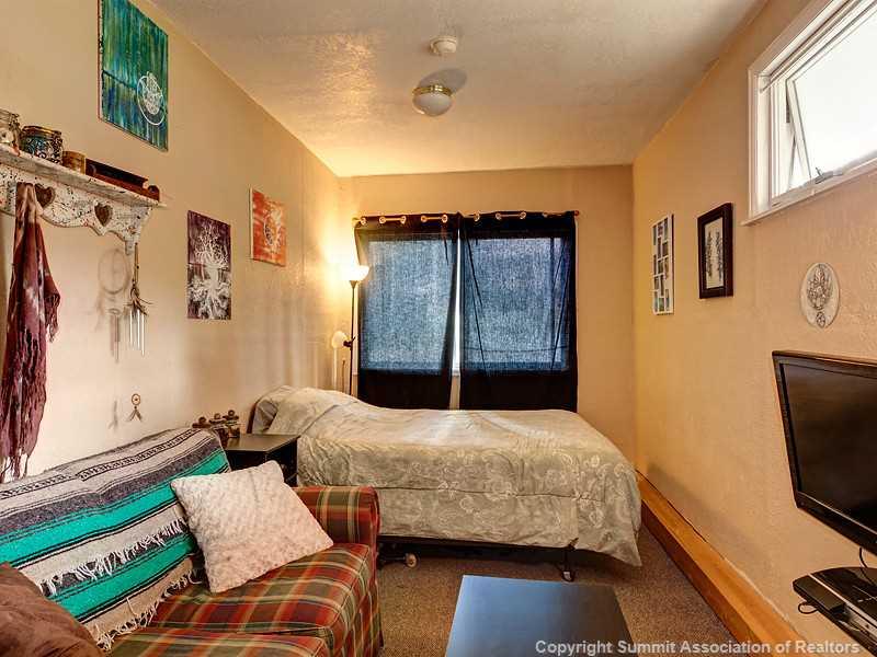 43 Red Feather Road Breckenridge, CO 80424 - Photo 7 of 12 a bedroom with a bed and a flat screen tv