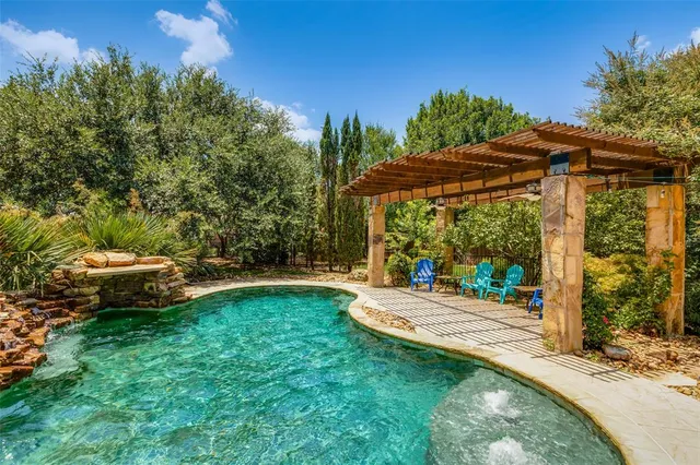 a view of a patio with table and chairs under an umbrella