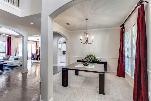 a view of a room with furniture and chandelier
