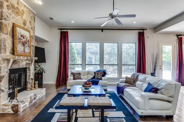 a living room with fireplace furniture and a large window