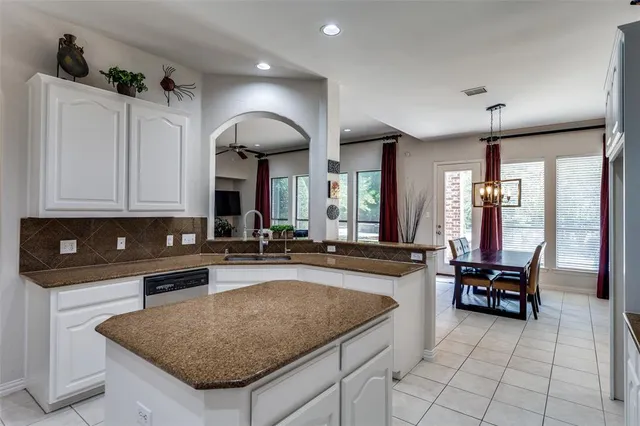 a kitchen with sink cabinets and dining table
