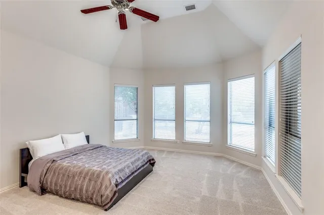 a bedroom with a large bed and a large window