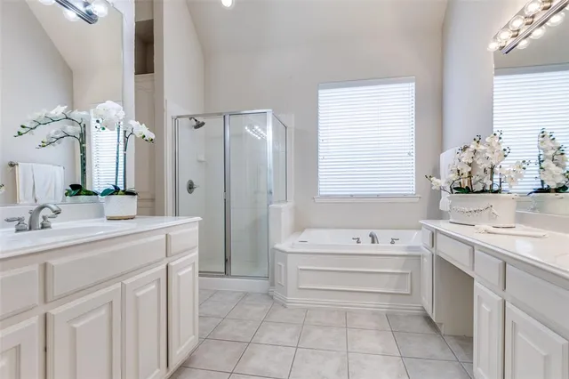 a bathroom with a sink vanity tub and shower