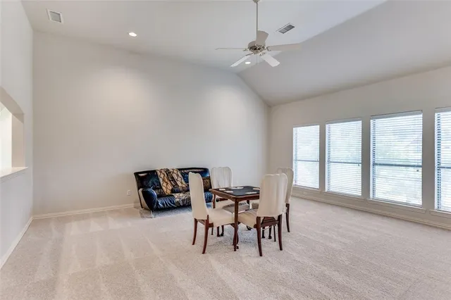 a dining room with furniture and window