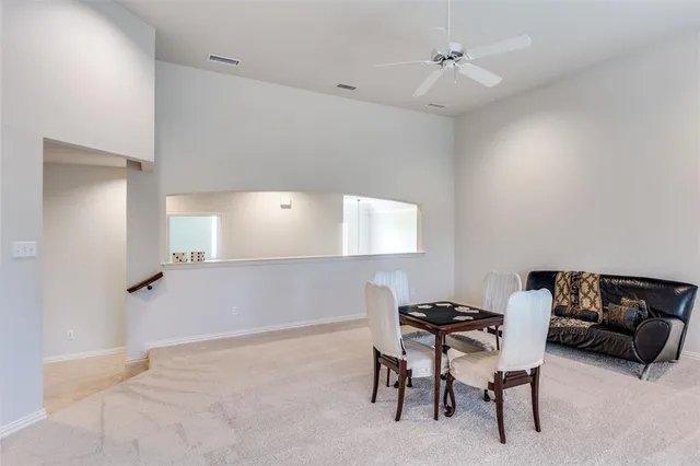 a living room with furniture and a ceiling fan