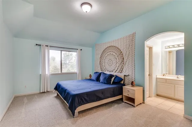 a spacious bedroom with a bed and window