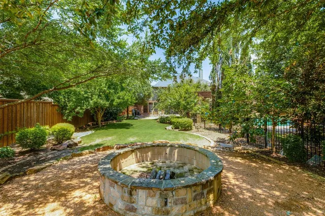 a view of a fountain in the backyard of house