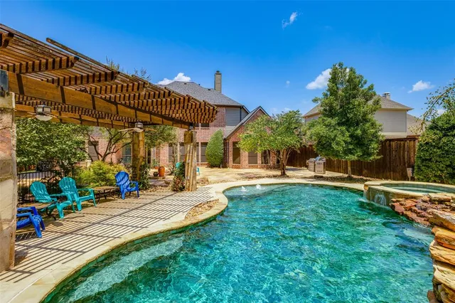 a view of a house with swimming pool and sitting area