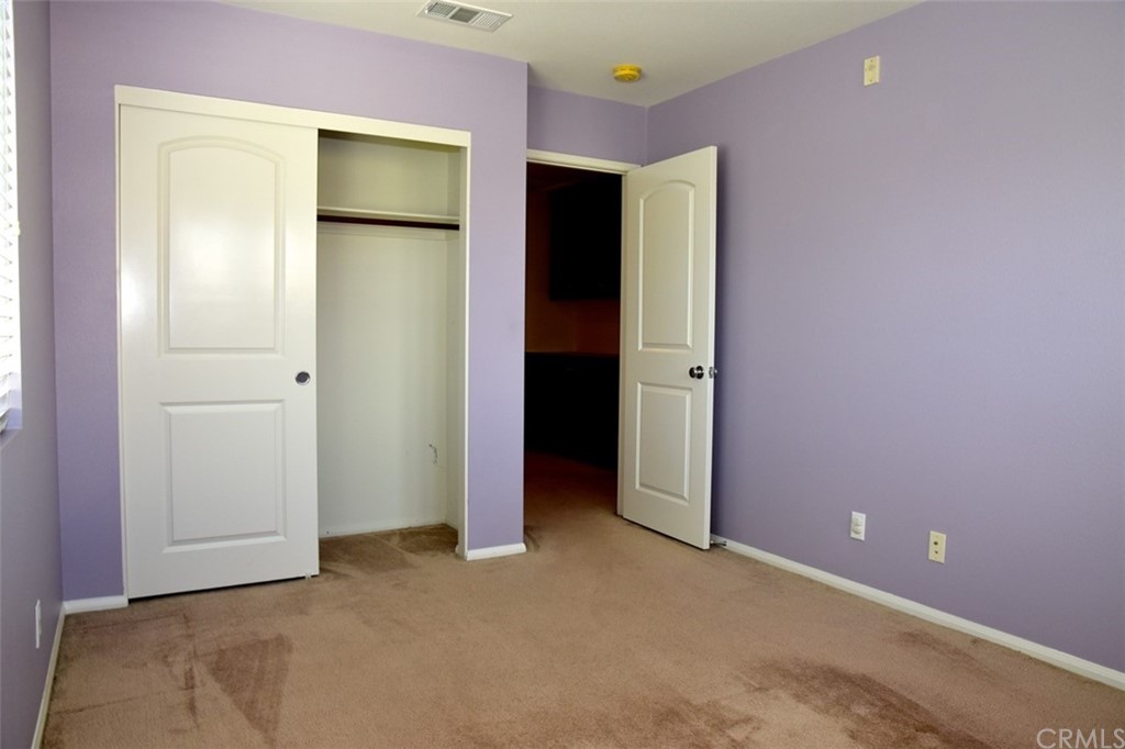 75 Courant Irvine, CA 92618 - Photo 11 of 27 an empty room with closet and mirror