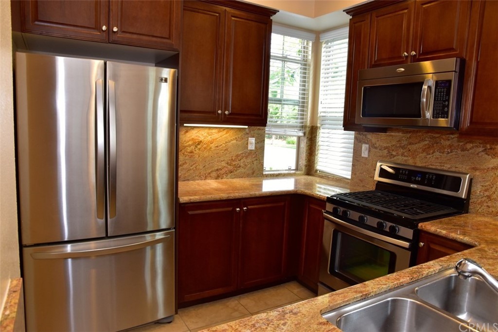 75 Courant Irvine, CA 92618 - Photo 9 of 27 a kitchen with a refrigerator stove and microwave