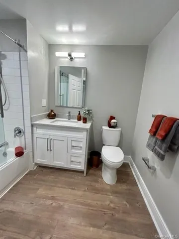 a bathroom with a sink toilet a mirror and tub