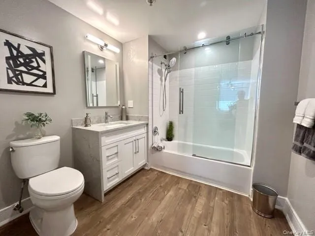 a bathroom with a double vanity sink toilet and shower
