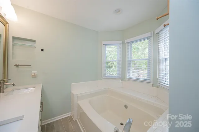 a white bath tub sitting next to a white sink
