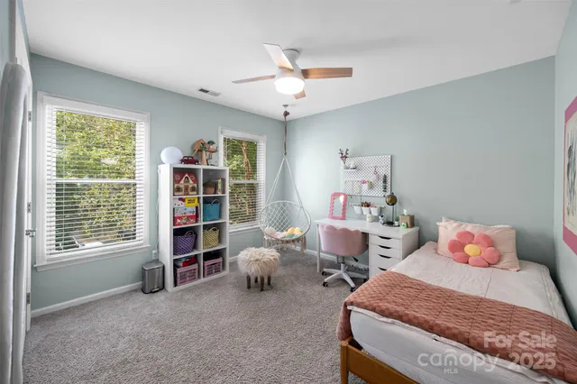 a bedroom with a bed and a book shelf