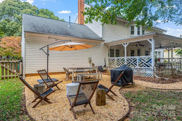 a view of a house with backyard and sitting area