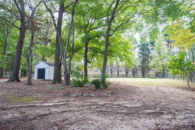 a house with lots of trees in the background