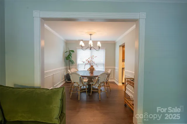 a view of a dining room with furniture and chandelier