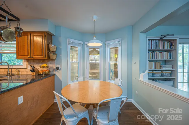 a view of a dining room with furniture and window