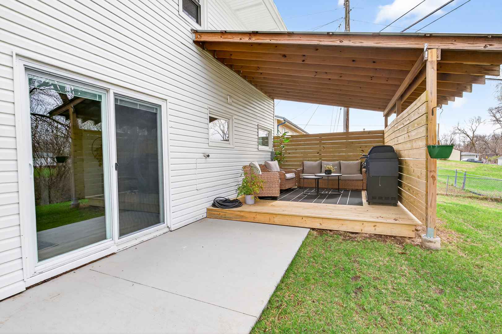 327 30th Avenue North Clinton, IA 52732 - Photo 31 of 38 a view of a patio with table and chairs potted plants and floor to ceiling window