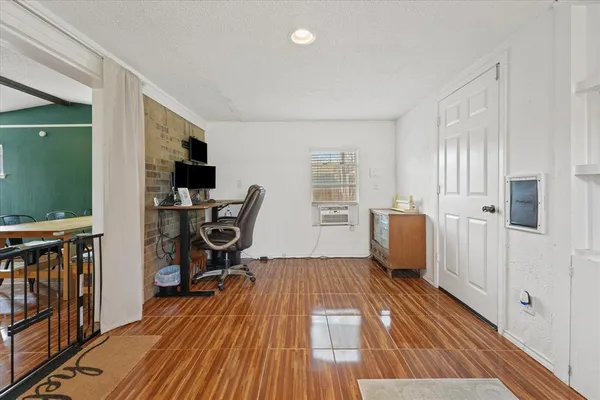 a bedroom with a large bed and a chandelier fan