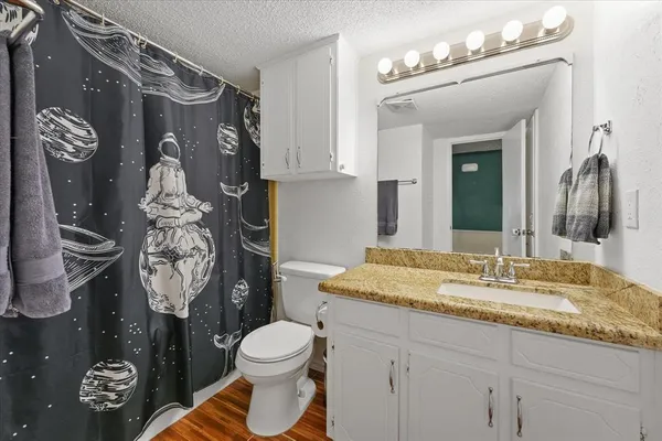 a view of a bedroom with baby crib and cabinet