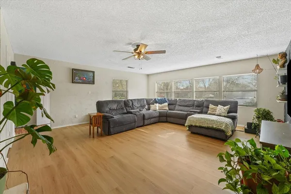 a living room with furniture and a wooden floor