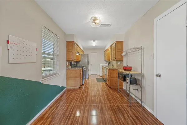 a workspace with wooden floor and windows