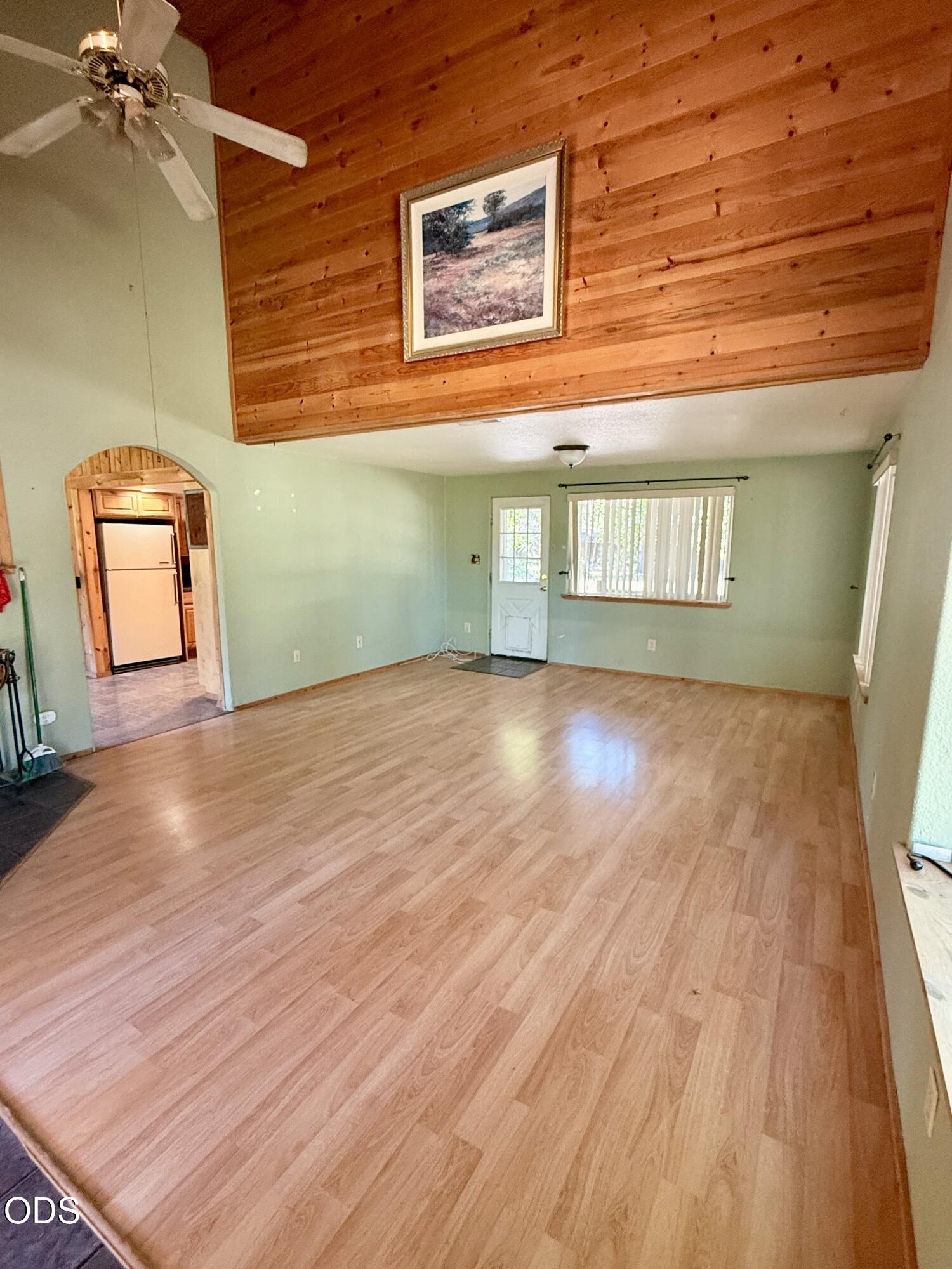 16025 Strawn Road La Pine, OR 97739 - Photo 11 of 95 a view of an empty room with wooden floor and a window