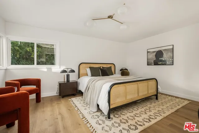 a bedroom with a bed and blue couch