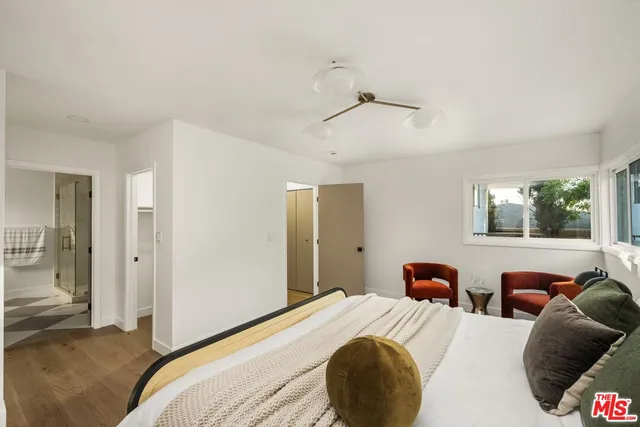 a bedroom with bed and window